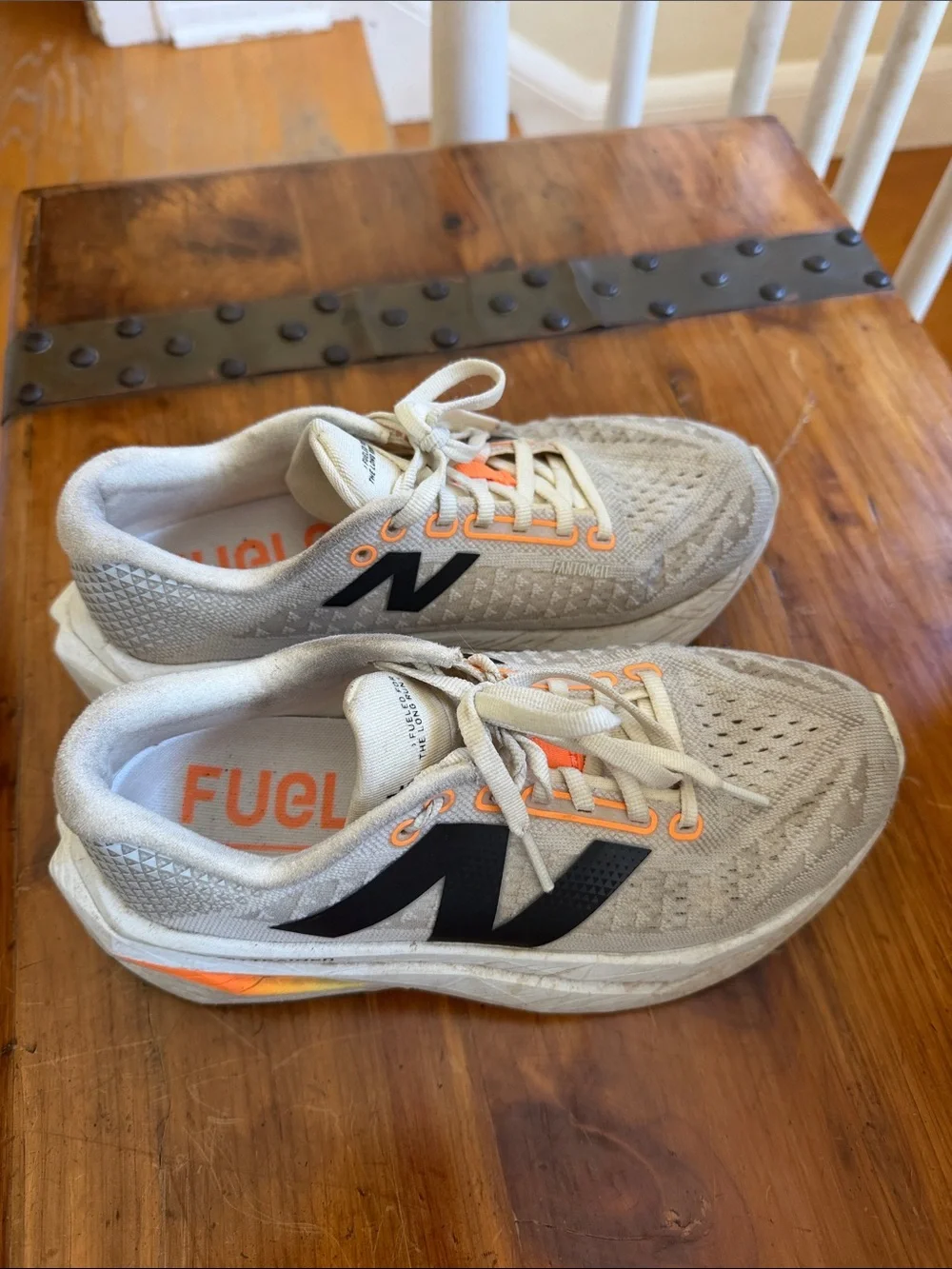 New Balance Women's Beige Athletic Shoes with Black Logo and Orange Accents